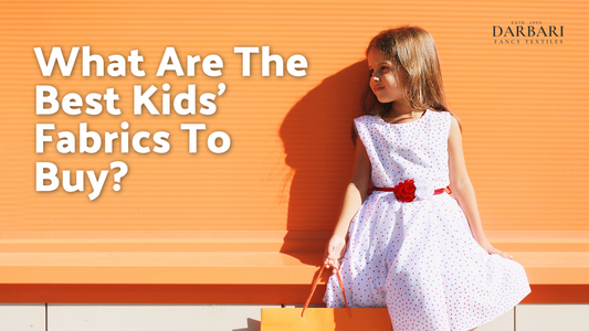 image of small girl wearing white dress and holding a orange color shopping bag. image is with the text on 'What Are The Best Kids’ Fabrics To Buy?'